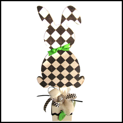 Black and off white checkered handmade wood bunny or egg home decor on a stand