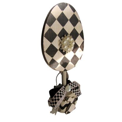 Black and off white checkered handmade wood bunny or egg home decor on a stand