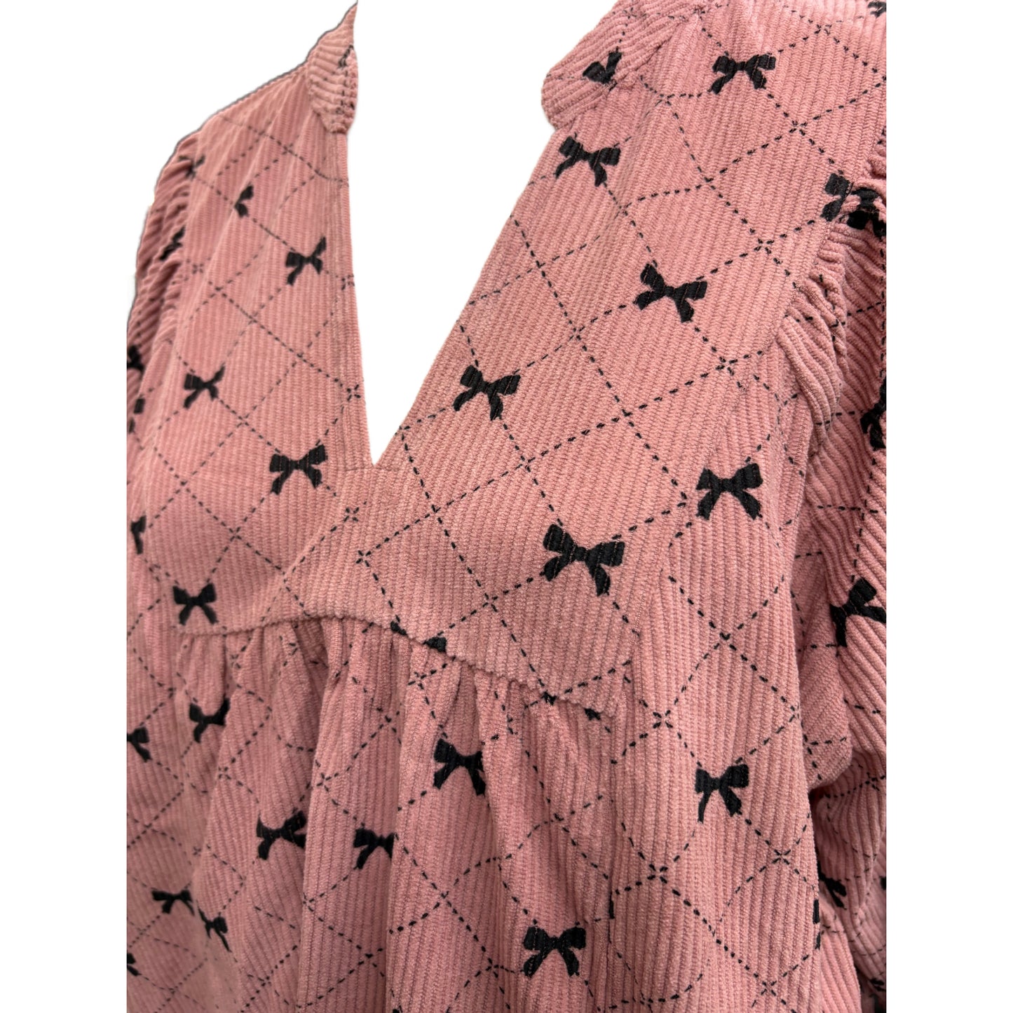 Long sleeve pink and black top with bow design