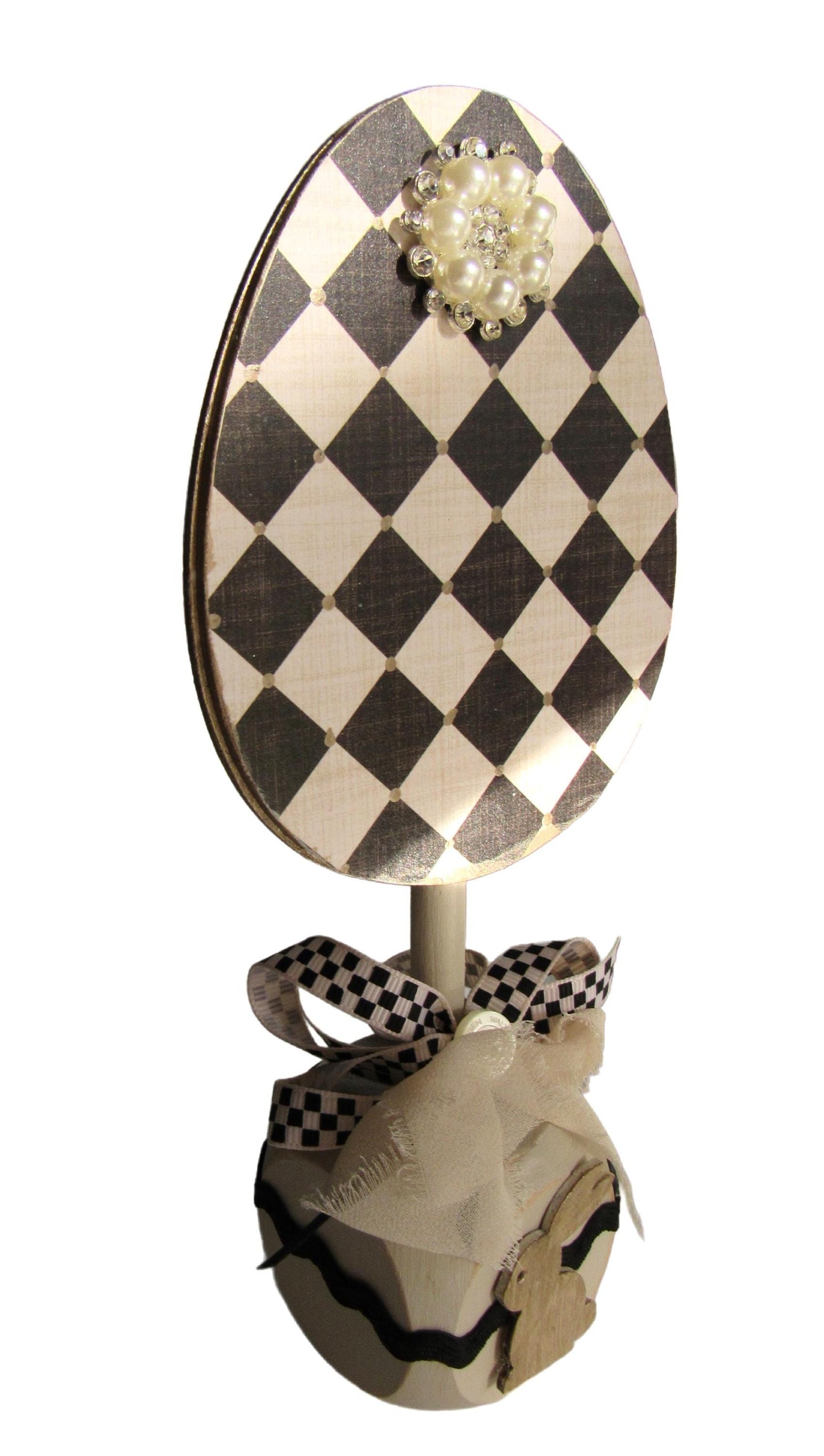 Black and off white checkered handmade wood bunny or egg home decor on a stand