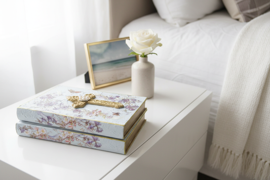 Decorative book stack with gold cross and floral details in luxury home décor