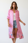 Close-up of botanical floral print on pink linen duster dress