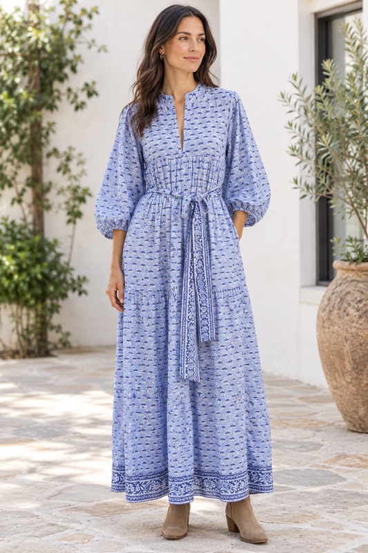 Lifestyle image of model in blue floral dress and short boots