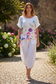 Model wearing white linen cropped balloon pants with watercolor floral top - outdoor lifestyle