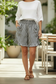 Women's black and white stripe cotton shorts with smocked waist, side ties, and ruffle hem