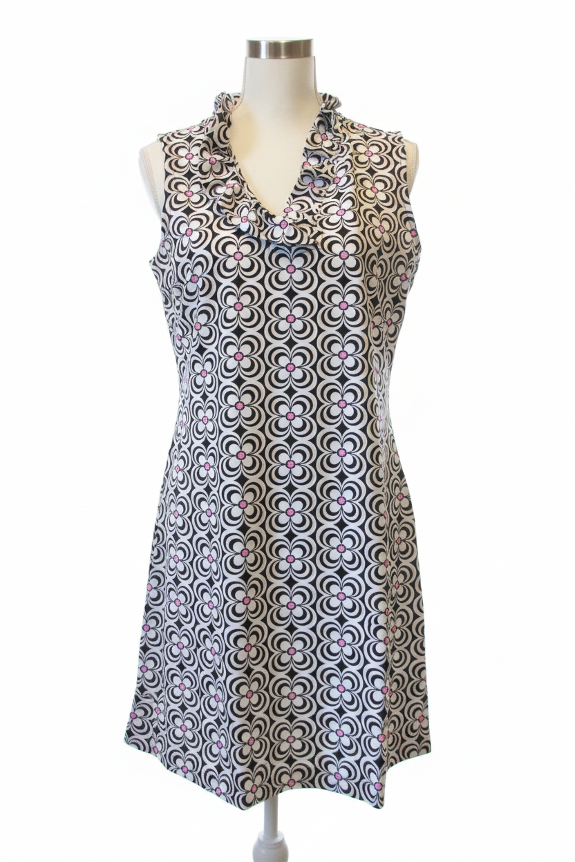 Retro floral shift dress with black and white pattern and pink accents on dress form