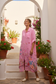 Pink Italian linen floral duster dress in Mediterranean courtyard