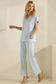Light blue V-neck top movement pose