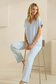 Light blue V-neck top seated pose